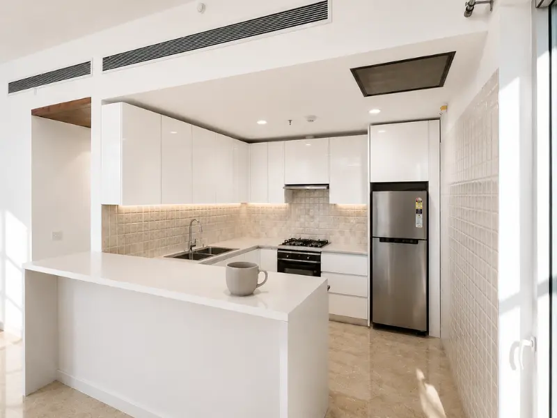 Modular kitchen with chimney and appliances in 2 BHK apartment for sale at Nova Residences, Sector 94 Noida