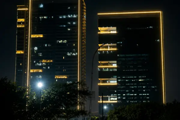 Supernova Astralis office tower lit up at night on the Noida Expressway