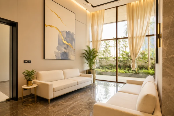 Bright marble-floored sitting lounge with garden view at Kalpataru Vista Sector 128 Noida